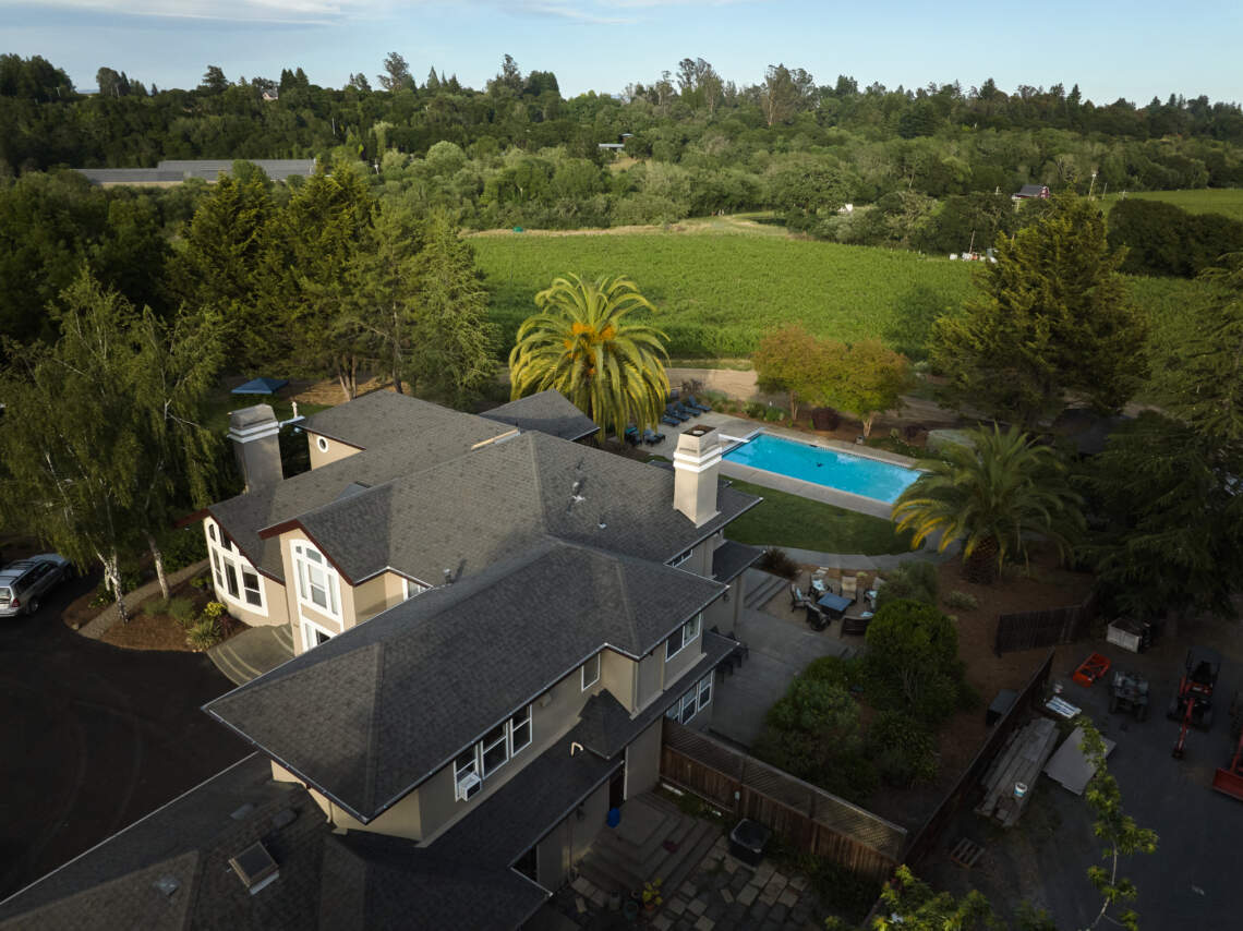 Overhead picture of a house with a pool in a vineyard